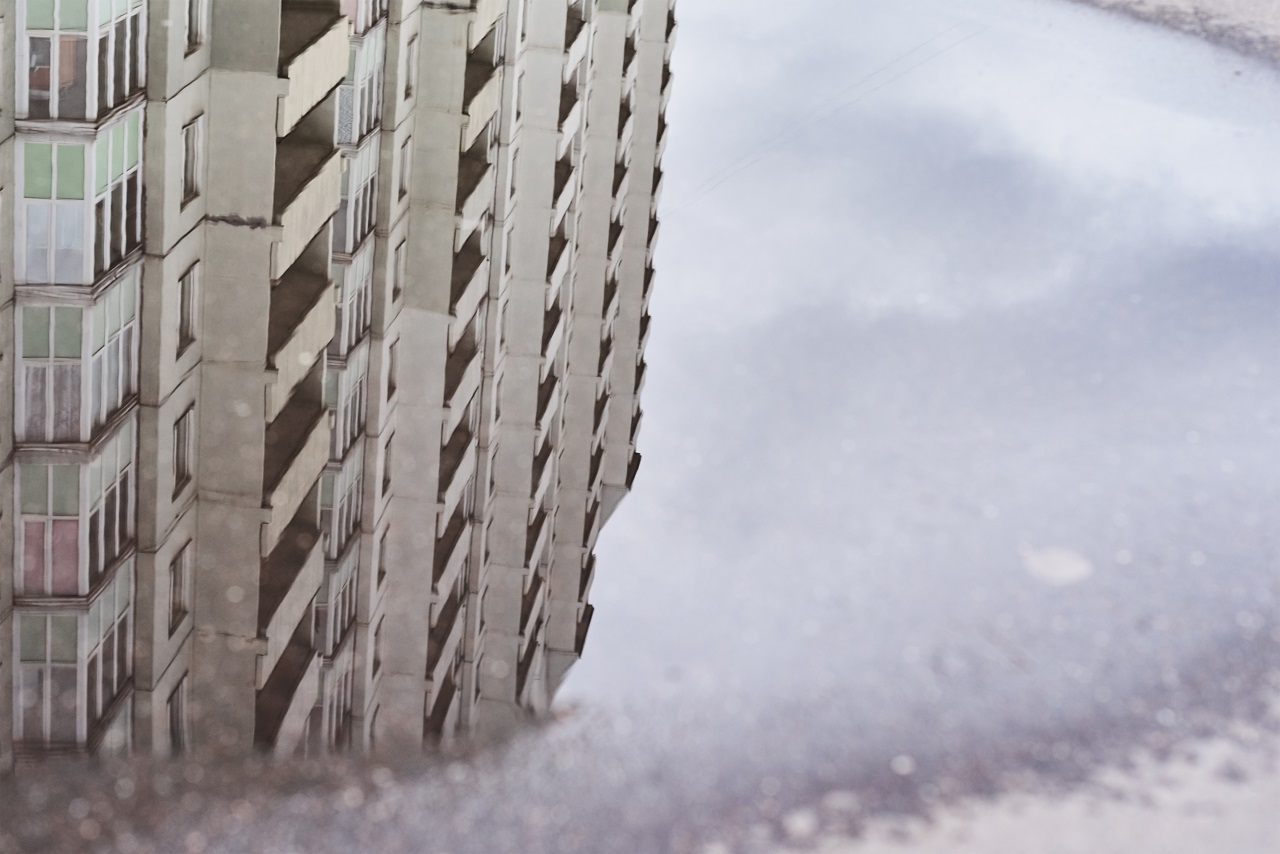 The reflection of a building on a puddle on a waterproof floor