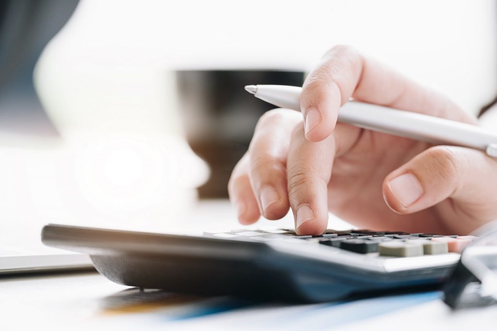 Close up of a person's hand making a budget