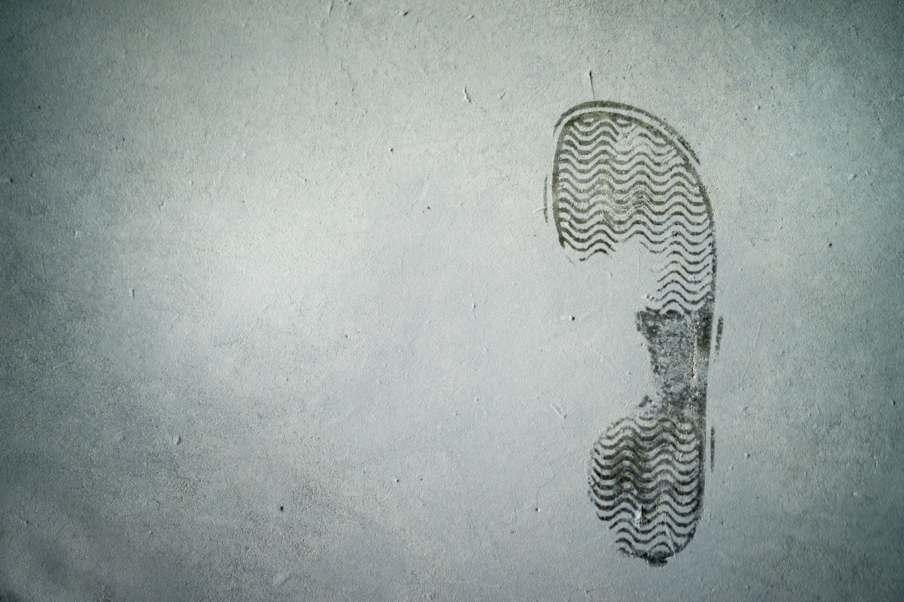 Wet footprint on dusty floor