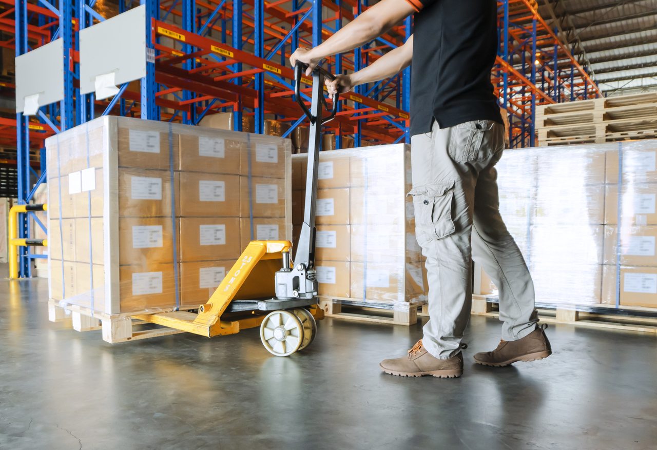 A man pulling cargo in a warehouse