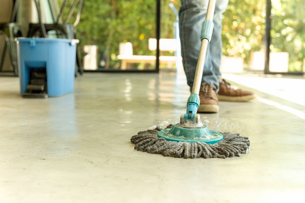 A man mopping the kitchen floor