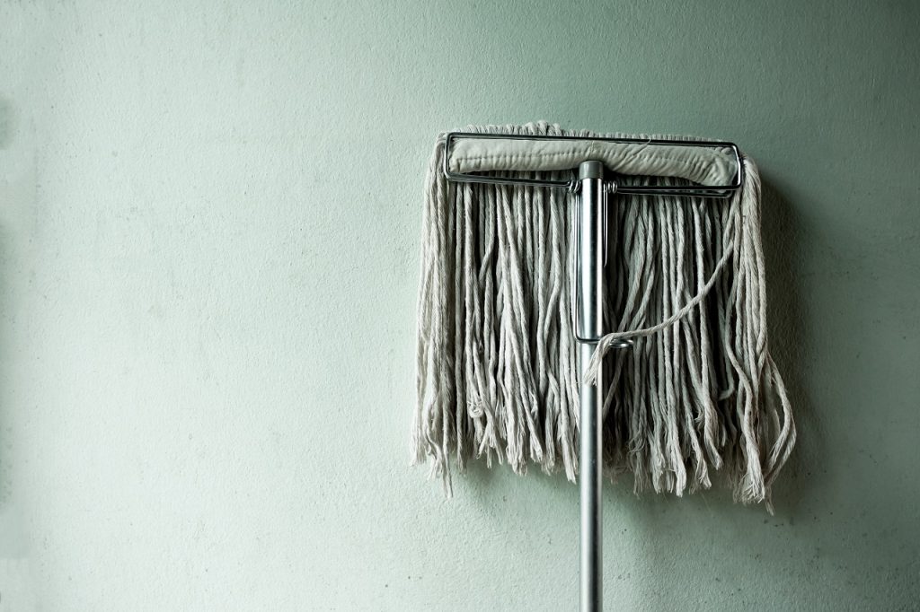 A mop propped up on a wall