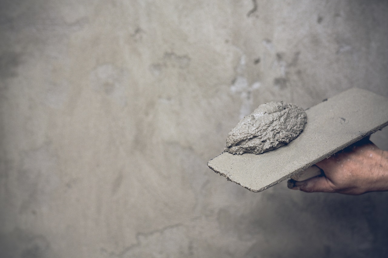 A plasterer making a concrete floor