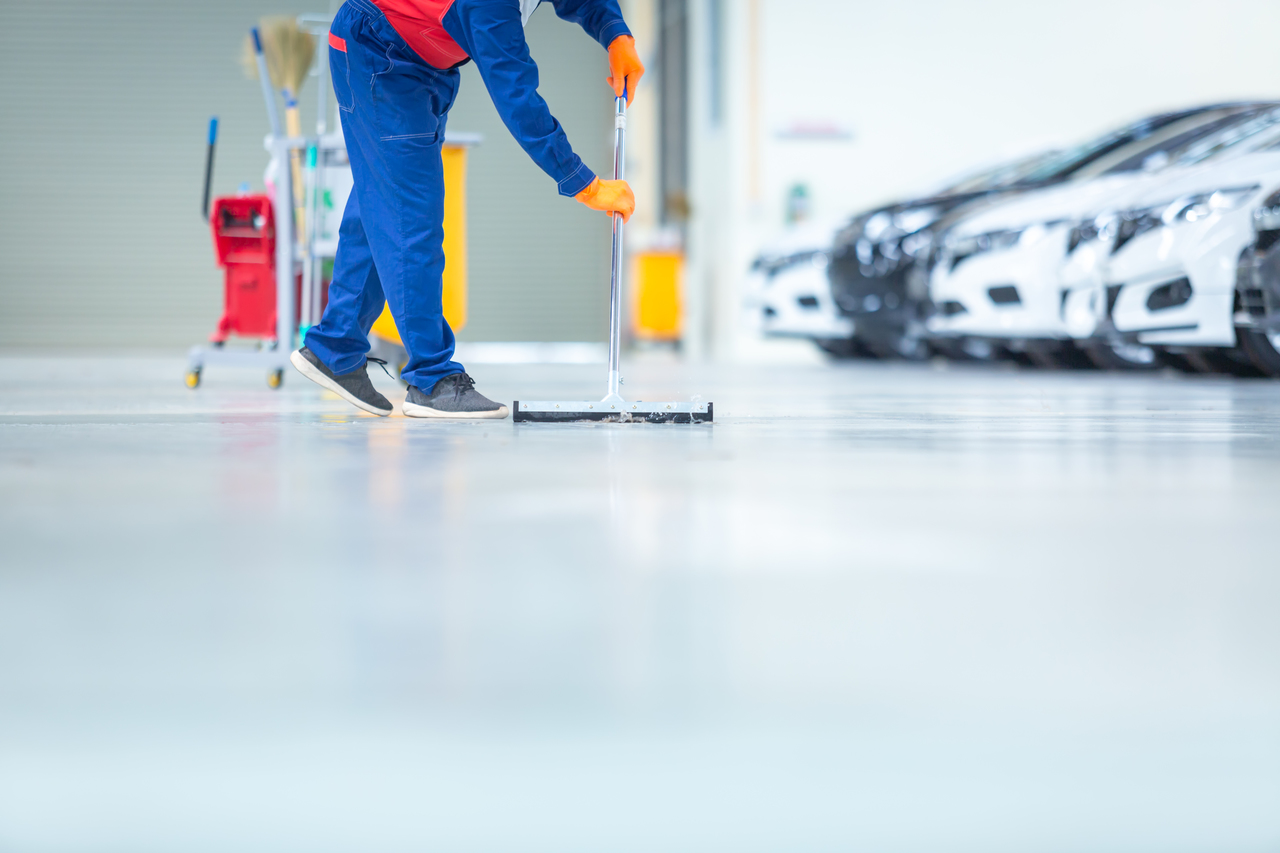 A worker cleaning the factory floor