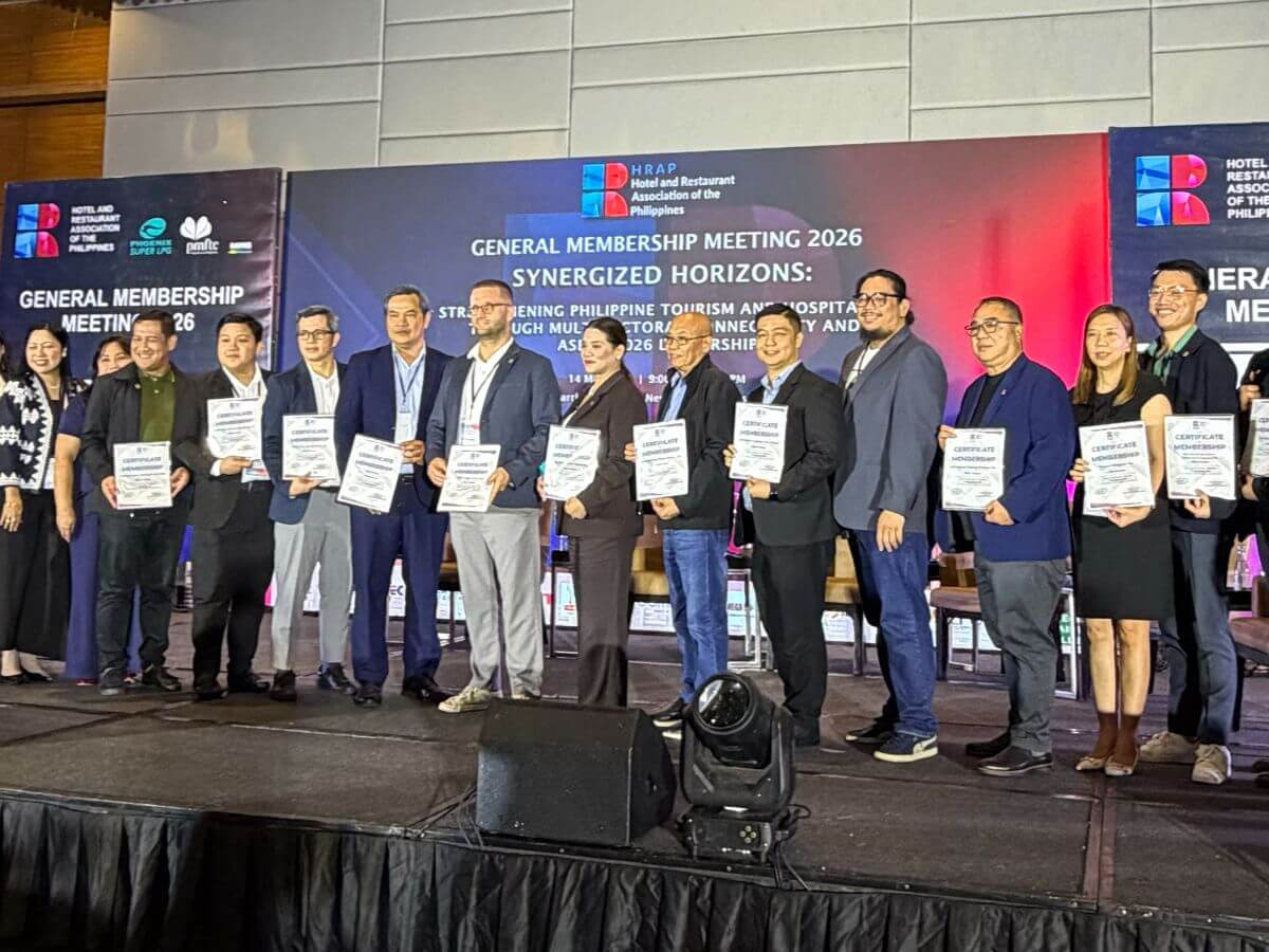 Newly inducted HRAP allied members holding membership certificates onstage during the 2026 general meeting